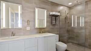 A new, modern, remodeled bathroom with a double vanity and walk-in shower 