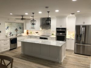 A modern kitchen with an island and white cabinetry 